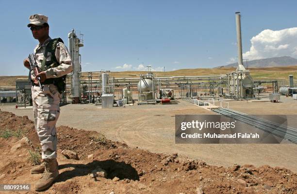 An Iraqi Kurdish soldier stands guard at the Tawke oil field near the town of Zacho on May 31, 2009 in Dohuk province about 250 miles north of...