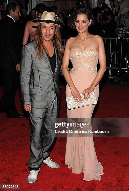 Designer John Galliano and actress Marion Cotillard attend "The Model as Muse: Embodying Fashion" Costume Institute Gala at The Metropolitan Museum...