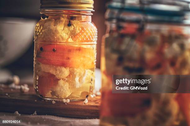 preserving organic cauliflower and carrots in jars - pickle relish stock pictures, royalty-free photos & images