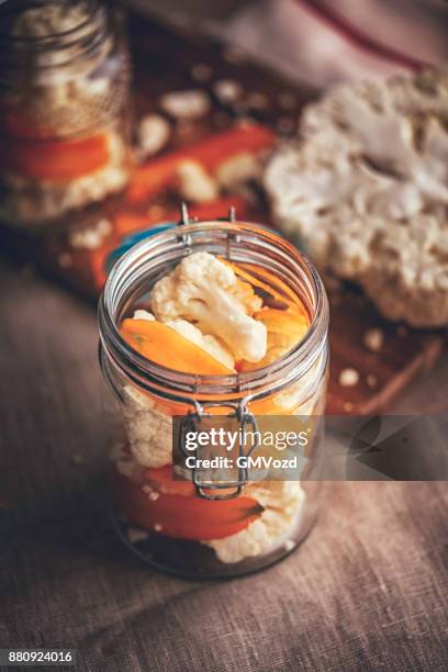 preserving organic cauliflower and carrots in jars - pickle relish stock pictures, royalty-free photos & images