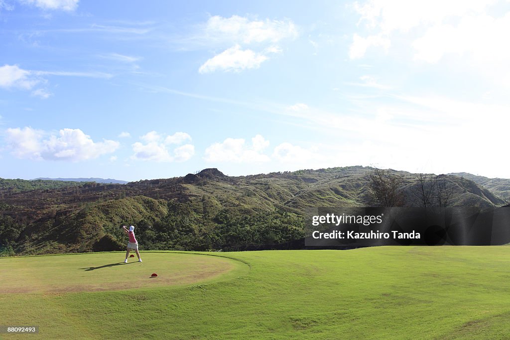 Woman playing golf