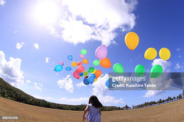 girl run after balloons - wide angle ストックフォトと画像