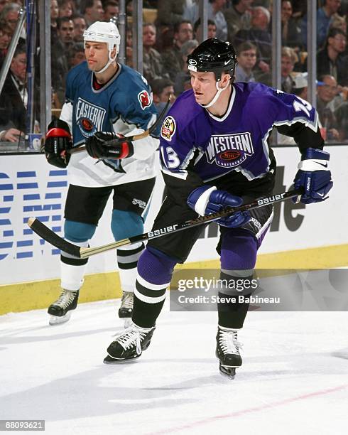 Mats Sundin of the Western Conference and the Toronto Maple Leafs is defended by Scott Stevens of the Eastern Conference and the New Jersey Devils...