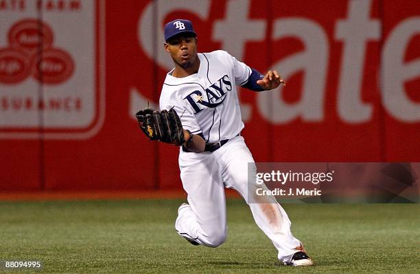 Outfielder Carl Crawford of the Tampa Bay Rays catches a fly ball against the Minnesota Twins during the game at Tropicana Field on May 30, 2009 in...