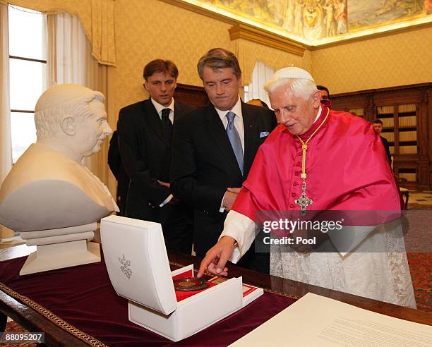 Pope Benedict XVI exchanges gifts with Ukrainian President Victor Yushchenko during their meeting at his private library on June 1, 2009 in Vatican...