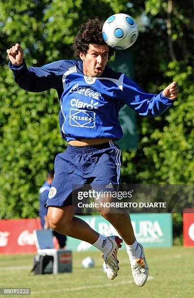 Footballer Cristian Riveros, heads the ball during a training session of the Paraguayan national team in Luque, Paraguay on June 1, 2009. The...