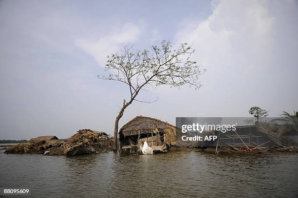 House are damaged due to a cyclone on the outskirts of Khulna some 400kms from Dhaka on June 1, 2009 Bangladesh and India launched major relief...