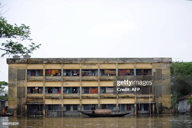 Bangladeshi villagers displaced by Cyclone Aila go about heir daily lives at a cyclone relief centre on the outskirts of Khulna some 400kms from...