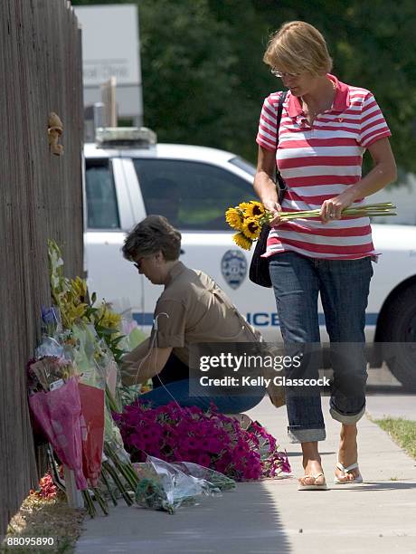 Julie Lawson carries flowers to a wall outside of Dr. George Tiller's Women's Health Care Services abortion clinic June 1, 2009 in Wichita, Kansas....