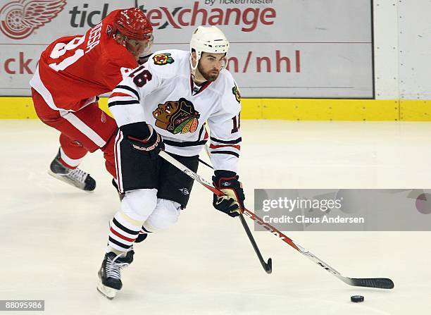 Marian Hossa of the Detroit Red Wings tries to check Andrew Ladd of the Chicago Black Hawks during Game Two of the Western Conference Championship...