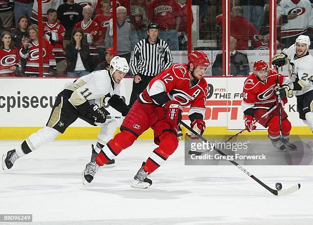 Eric Staal of the Carolina Hurricanes carries the puck ahead of brother Jordan Staal of the Pittsburgh Penguins during Game Four of the Eastern...