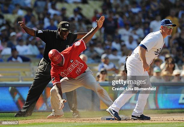 Gary Matthews Jr. #24 of the Los Angeles Angels of Anaheim is safe at third base in the 9th inning against Mark Loretta of the Los Angeles Dodgers at...