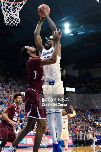 Charlie Moore of the Kansas Jayhawks goes up against Trayvon Reed of the Texas Southern Tigers at Allen Fieldhouse on November 21, 2017 in Lawrence,...