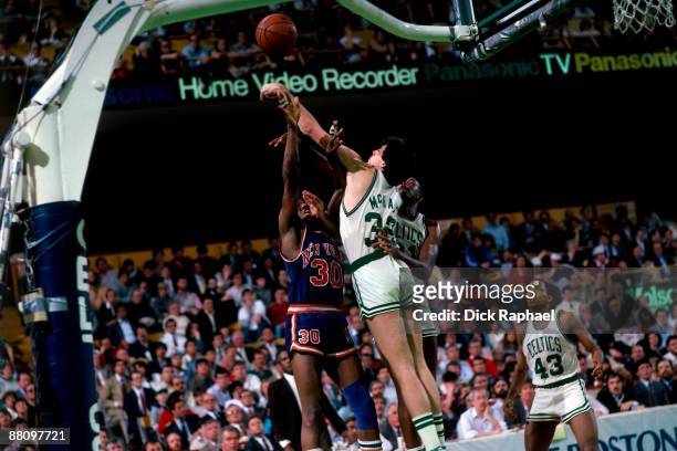 Kevin McHale of the Boston Celtics blocks a shot attempt by Bernard King of the New York Knicks during a game played in 1984 at the Boston Garden in...