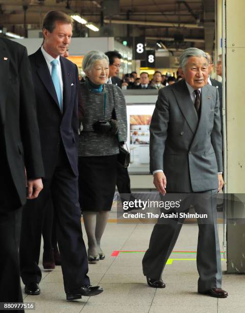 Grand Duke Henri of Luxembourg and his daughter Princess Alexandra of Luxembourg are escorted to the special train by Emperor Akihito and Empress...