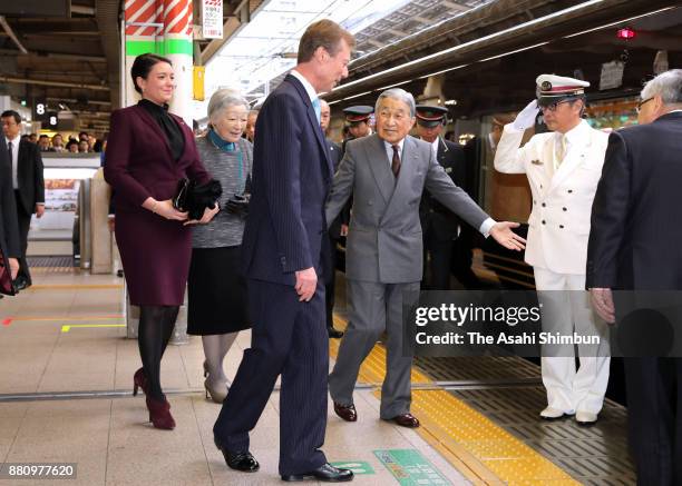 Grand Duke Henri of Luxembourg and his daughter Princess Alexandra of Luxembourg are escorted to the special train by Emperor Akihito and Empress...