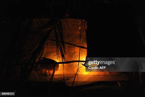 Displaced Bangladeshi villager takes shelter in a makeshift dwelling on the outskirts of Khulna some 400 kms from Dhaka on June 1, 2009. Bangladesh...