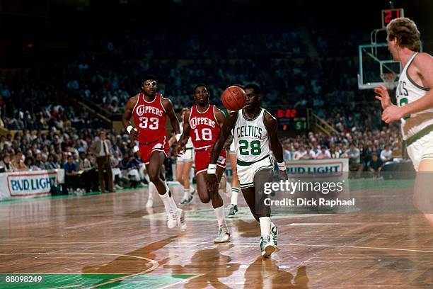 Quinn Buckner and Larry Bird of the Boston Celtics run the break against Derek Smith and Jerome Whitehead of the San Diego Clippers during a game...