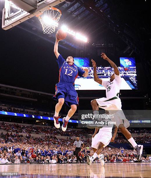 Brady Morningstar of the Kansas Jayhawks drives for a shot attempt against Durrell Summers of the Michigan State Spartans during the third round of...