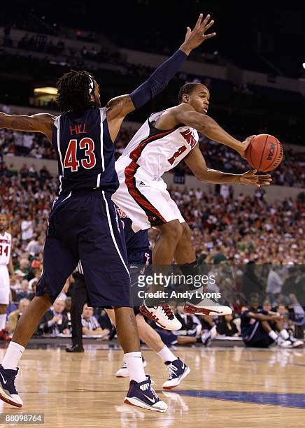 Preston Knowles of the Louisville Cardinals looks to pass the ball against Jordan Hill the Arizona Wildcats during the third round of the NCAA...