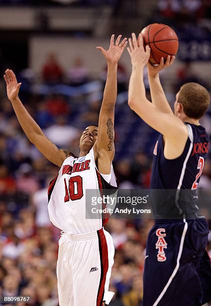 Edgar Sosa of the Louisville Cardinals attempts to block a shot attempt by Zane Johnson of the Arizona Wildcats during the third round of the NCAA...
