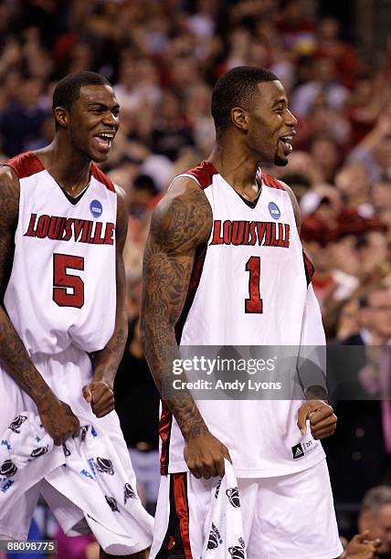 Terrence Williams and Earl Clark of the Louisville Cardinals celebrate in the final minutes of their103-64 win against the Arizona Wildcats during...