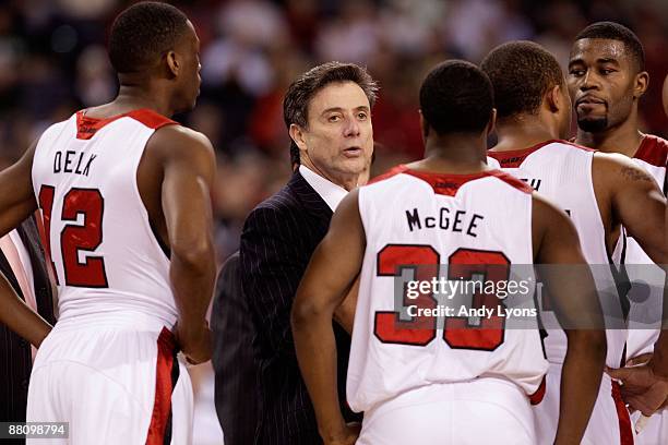 Head coach Rick Pitino of the Louisville Cardinals talks with his players during a timeout against the Arizona Wildcats during the third round of the...