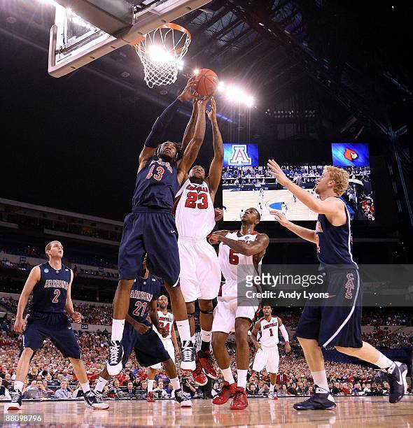 Jordan Hill of the Arizona Wildcats fights for a rebound against Terrence Jennings of the Louisville Cardinals during the third round of the NCAA...