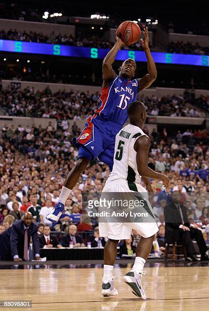 Tyshawn Taylor of the Kansas Jayhawks attempts a shot against Travis Walton of the Michigan State Spartans during the third round of the NCAA...