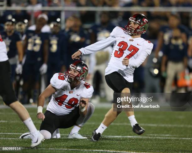 Jake Collins and Ryan Nuss of the Western Kentucky Hilltoppers look up as the field goal attempt misses during first quarter action against the...