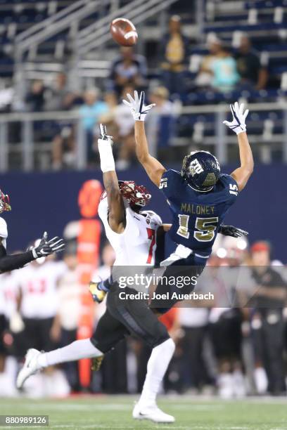 Joe Brown of the Western Kentucky Hilltoppers defends against Austin Maloney of the Florida International Golden Panthers as he attempts to catch the...