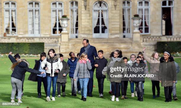 French Prime Minister Edouard Philippe arrive to plant an apple tree with pupils from the primary school of Theophile Gautier in le Havre, in the...