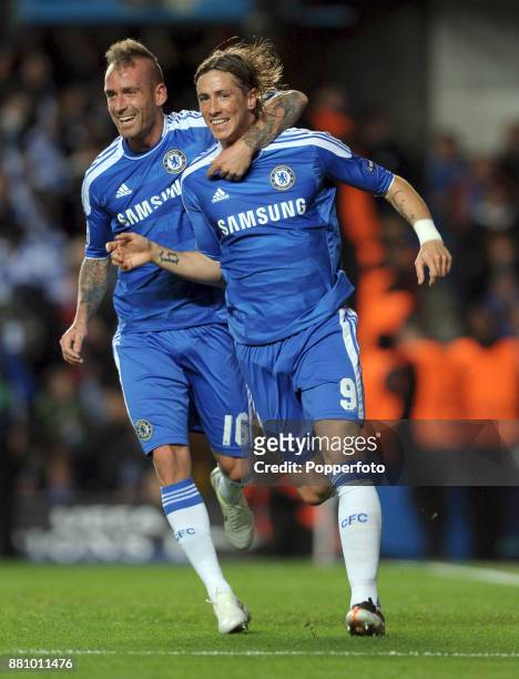 Fernando Torres of Chelsea celebrates with team mate Raul Meireles after scoring his 2nd goal during the UEFA Champions League match between Chelsea...