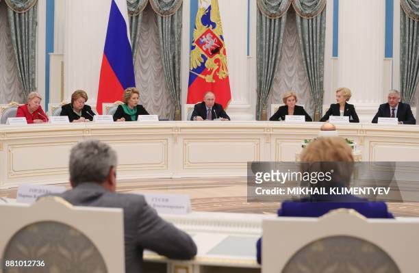 Russian President Vladimir Putin chairs a meeting on child policy at the Kremlin in Moscow on November 28, 2017. President Vladimir Putin on November...