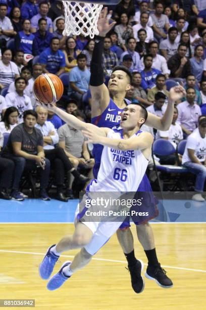 Roger Ray Pogoy of the Philippines tries to block a lay-up attempt by Kai-Yan Lee of Chinese Taipei during their FIBA World Cup Qualifying Match....