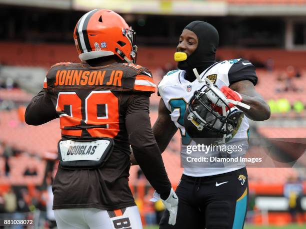 Safety Tashaun Gipson of the Jacksonville Jaguars and running back Duke Johnson Jr. #29 of the Cleveland Browns embrace prior to a game on November...