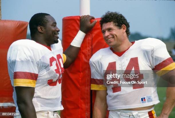 Running back George Rogers and John Riggins of the Washington Redskins looks on together in this photo during a Washington Redskins practice circa...