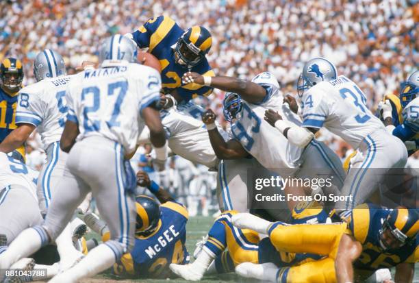 Greg Bell of the Los Angeles Rams dives over the top against the Detroit Lions during an NFL football game September 11, 1988 at Anaheim Stadium in...