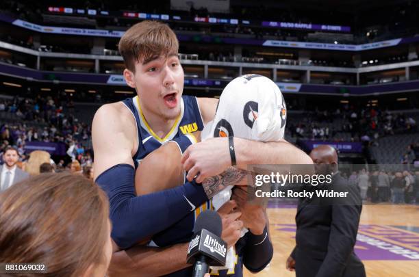 Juan Hernangomez of the Denver Nuggets grabs teammate Gary Harris during an interview after the game against the Sacramento Kings on November 20,...