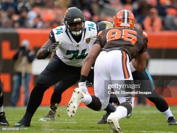 Left tackle Cam Robinson of the Jacksonville Jaguars engages defensive end Myles Garrett of the Cleveland Browns in the first quarter of a game on...