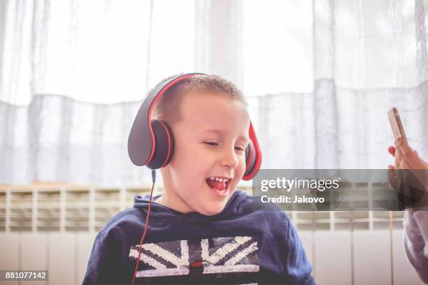 siblings - -bonding - electronic listening device stock pictures, royalty-free photos & images