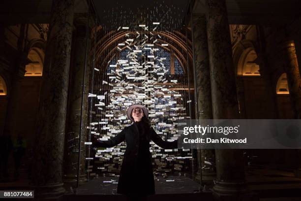 Stage designer Es Devlin poses beside a 'Christmas Tree' in the entrance to the V&A, Victoria and Albert museum on November 28, 2017 in London,...