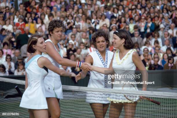 Francoise Durr of France and her partner Betty Stove of the Netherlands shake hands with Evonne Goolagong of Australia and Peggy Michel of the USA...