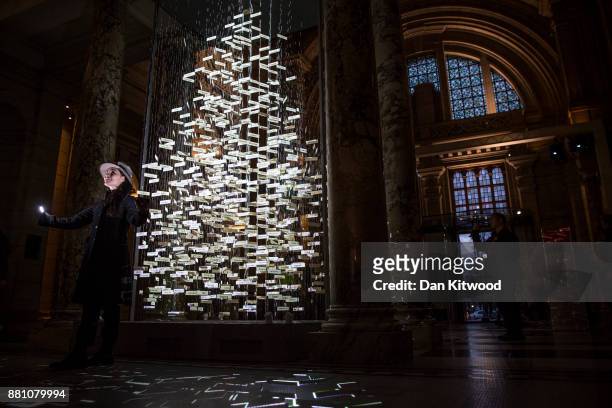Stage designer Es Devlin poses beside a 'Christmas Tree' in the entrance to the V&A, Victoria and Albert museum on November 28, 2017 in London,...