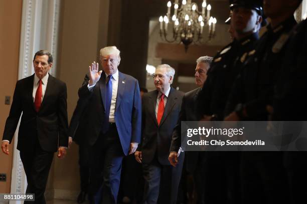 President Donald Trump joins Sen. John Barrasso and Senate Majority Leader Mitch McConnell as they head into the weekly Senate Republican Policy...