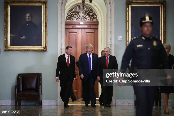 President Donald Trump joins Sen. John Barrasso and Senate Majority Leader Mitch McConnell as they head into the weekly Senate Republican Policy...