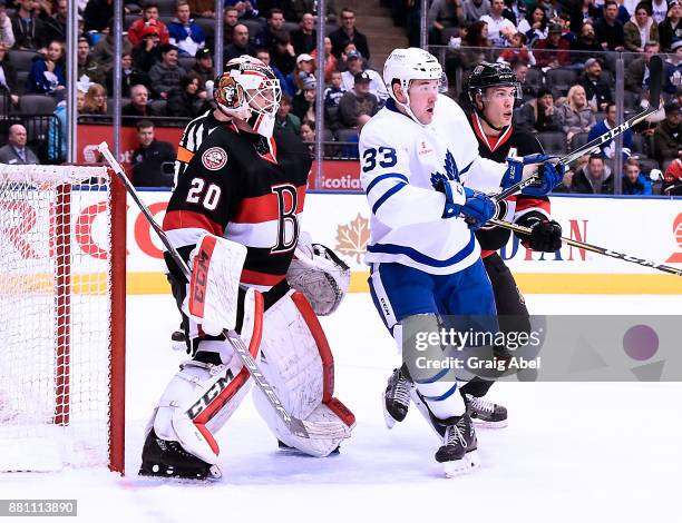 Frederik Gauthier of the Toronto Marlies battles with goalie Daniel Taylor and Andreas Englund of the Belleville Senators during AHL game action on...