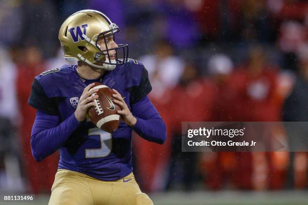 Quarterback Jake Browning of the Washington Huskies passes against the Washington State Cougars at Husky Stadium on November 25, 2017 in Seattle,...