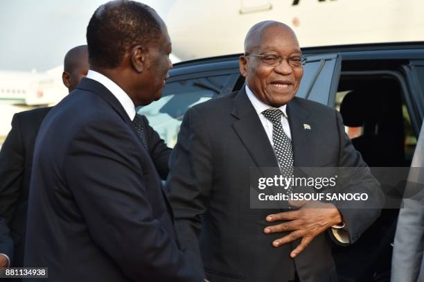 President of Ivory Coast Alassane Ouattara welcomes president of South Africa Jacob Zuma upon his arrival at the Felix Houphouet- Boigny airport in...