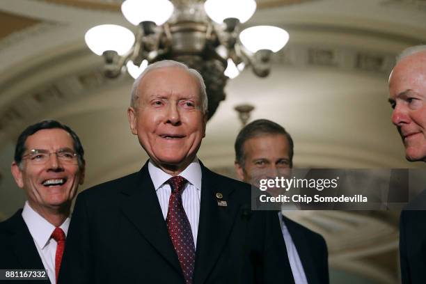 Sen. John Barrasso , Senate Finance Committee Chairman Orrin Hatch , Sen. John Thune and Senate Majority Whip John Cornyn talk with reporters...